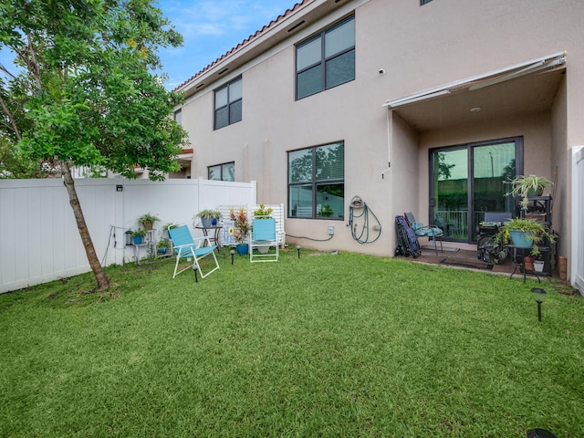 rear view of house with a yard