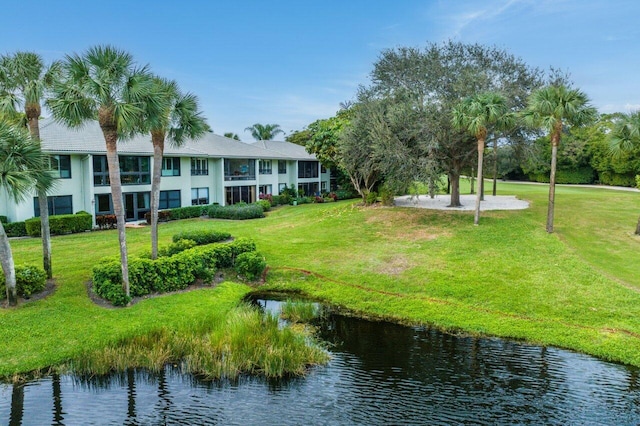 surrounding community featuring a water view and a yard