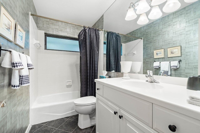 full bathroom featuring tile walls, vanity, shower / bath combination with curtain, tile patterned floors, and toilet