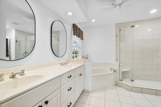 bathroom with tile patterned flooring, plus walk in shower, and vanity