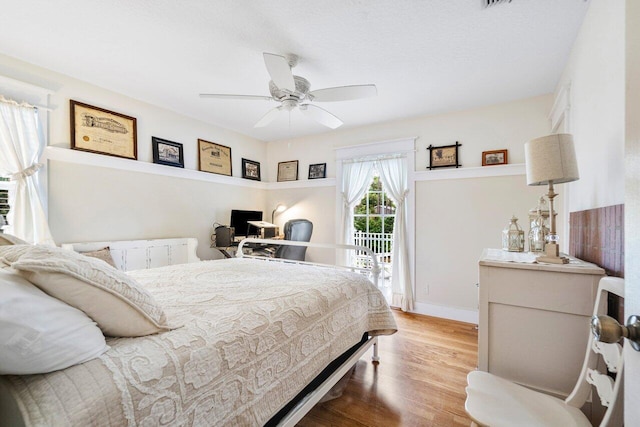 bedroom featuring ceiling fan, hardwood / wood-style flooring, and access to outside