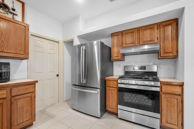 kitchen with appliances with stainless steel finishes and light tile patterned floors