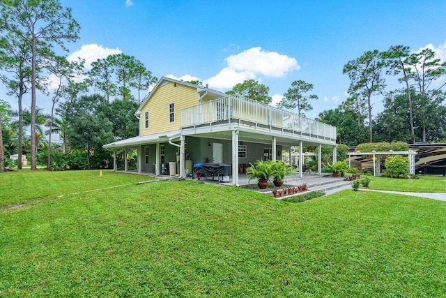 rear view of property with a yard and a patio area