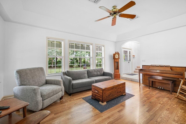 living room with ceiling fan, light wood-type flooring, and a healthy amount of sunlight