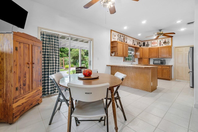 tiled dining space featuring ceiling fan