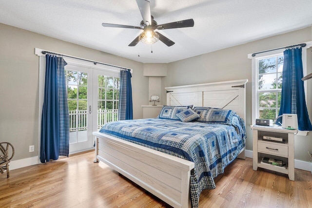 bedroom featuring multiple windows, ceiling fan, hardwood / wood-style floors, and access to outside