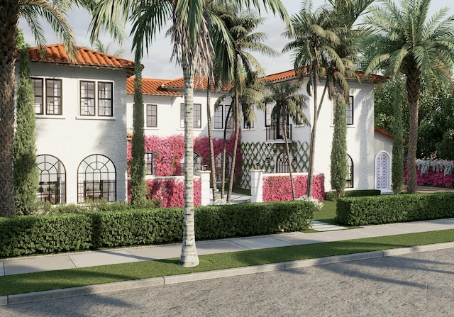 view of front of property featuring stucco siding and a tile roof