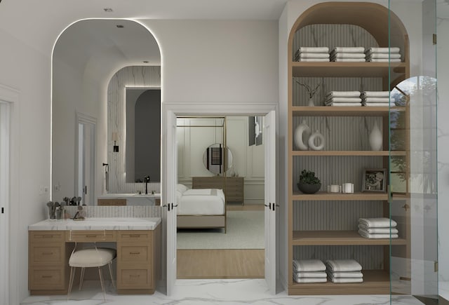 ensuite bathroom with ensuite bath and marble finish floor