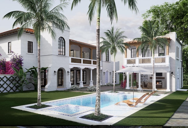 rear view of house with a patio, a balcony, and a lawn