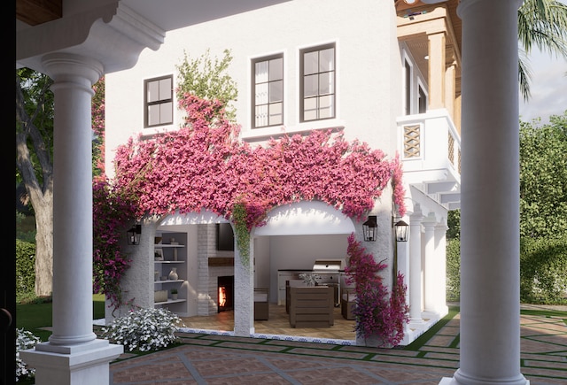 doorway to property with a patio area and exterior kitchen