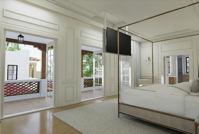 bedroom with access to exterior and wood finished floors