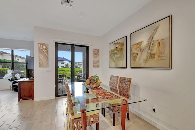 dining room featuring a wealth of natural light, visible vents, and baseboards