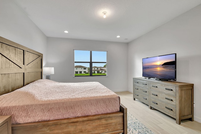 bedroom with recessed lighting, baseboards, and light wood finished floors