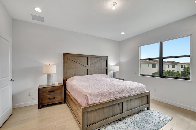 bedroom featuring visible vents, recessed lighting, light wood-style floors, and baseboards