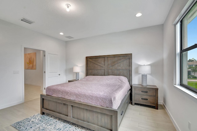 bedroom with recessed lighting, visible vents, and baseboards