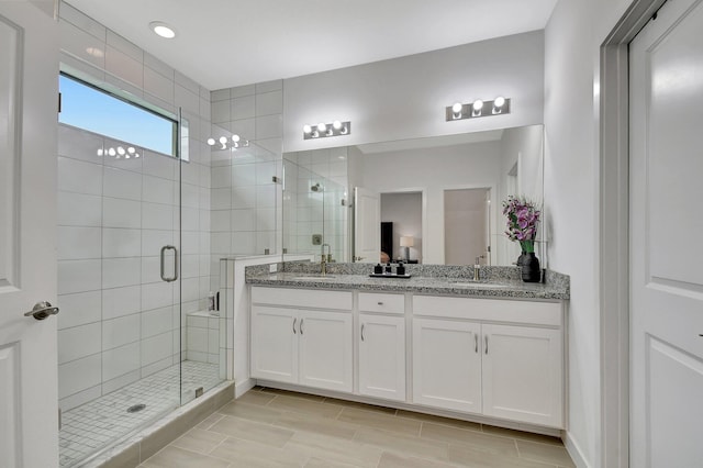 bathroom with vanity and a shower with shower door