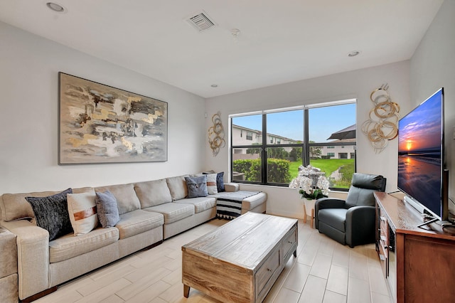 living room featuring visible vents and recessed lighting