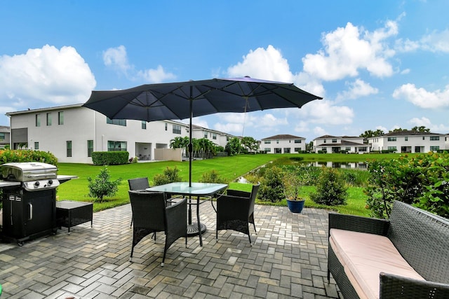 view of patio / terrace with grilling area, a residential view, and outdoor dining space