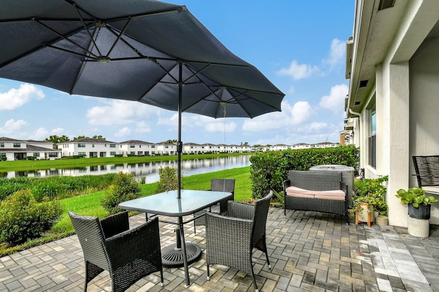 view of patio / terrace with outdoor dining area and a water view