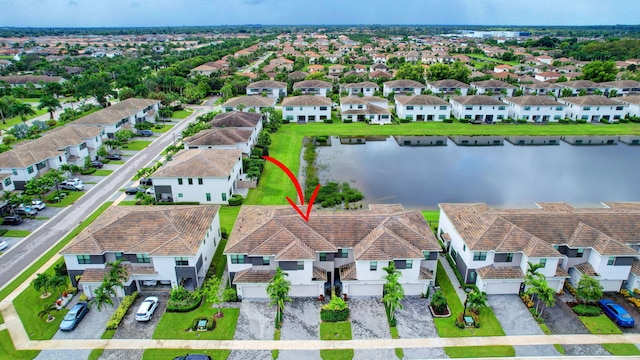 birds eye view of property featuring a residential view and a water view