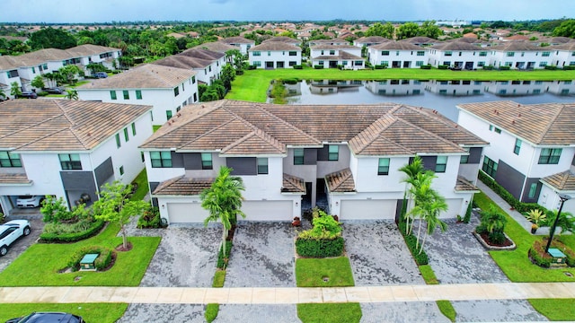 drone / aerial view with a residential view and a water view