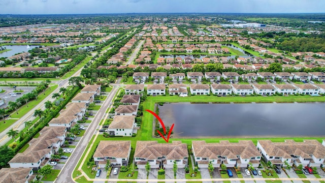 birds eye view of property featuring a residential view and a water view