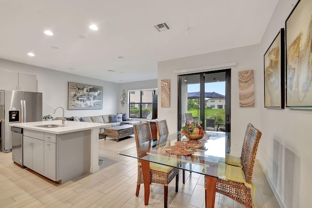 dining space featuring light hardwood / wood-style floors and sink