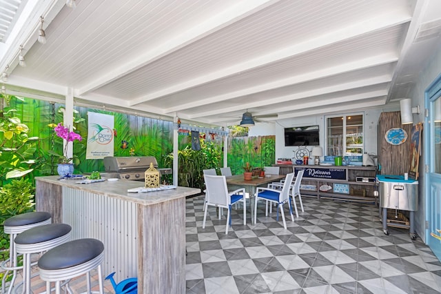 view of patio with an outdoor kitchen, outdoor wet bar, grilling area, and outdoor dining space