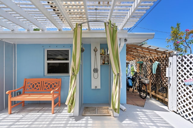 property entrance featuring a pergola