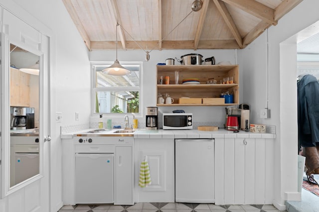 kitchen with refrigerator, open shelves, tile counters, lofted ceiling with beams, and white microwave