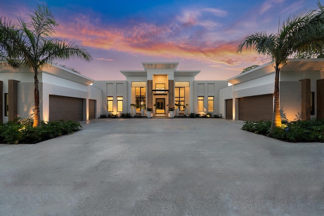 contemporary home featuring a garage and a carport