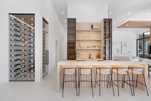 interior space featuring a breakfast bar area and sink