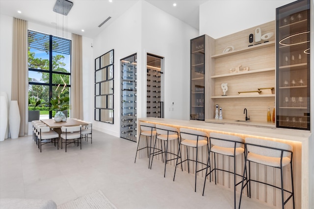 kitchen with a high ceiling, a kitchen bar, and sink