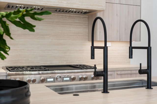 details with light brown cabinetry, decorative backsplash, and exhaust hood