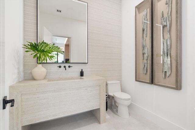 bathroom with tile patterned flooring, vanity, and toilet