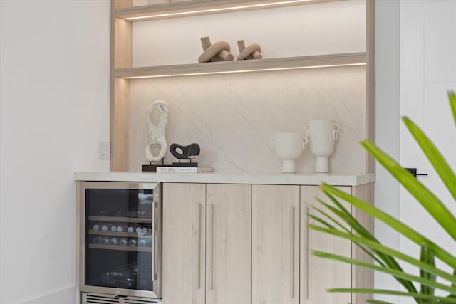 bar with light brown cabinets and wine cooler