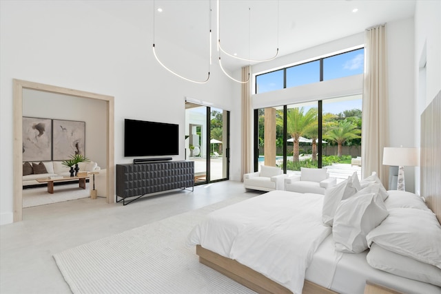 bedroom featuring a high ceiling and access to outside