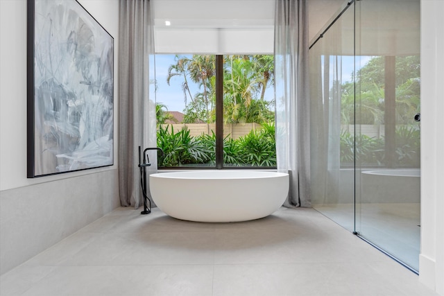 bathroom with a tub to relax in