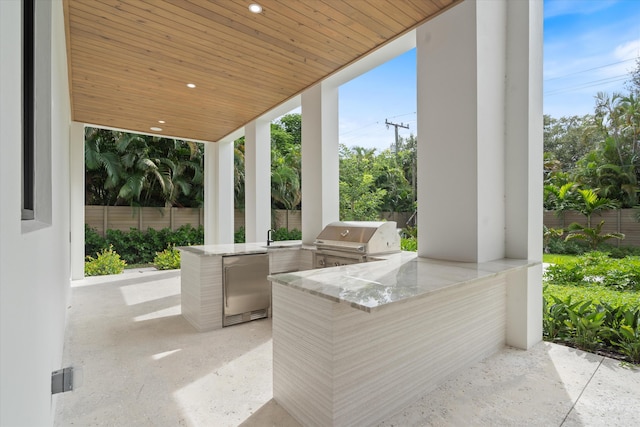 view of patio / terrace with an outdoor kitchen, area for grilling, and sink