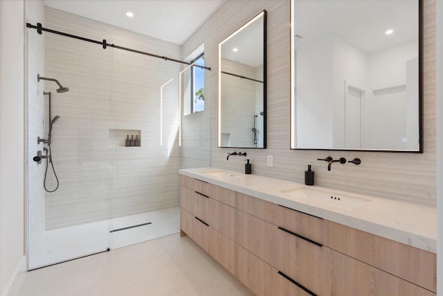 bathroom featuring tile walls, vanity, decorative backsplash, and a tile shower