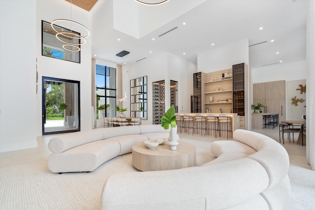 tiled living room featuring a high ceiling