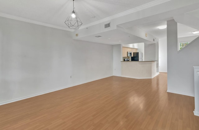 unfurnished living room featuring crown molding, baseboards, light wood-type flooring, and visible vents