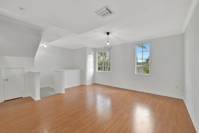 bonus room featuring a notable chandelier and light hardwood / wood-style floors