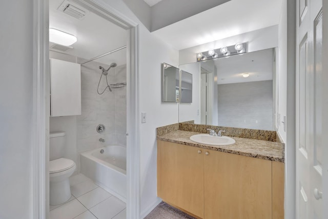 full bathroom with tiled shower / bath combo, tile patterned floors, vanity, and toilet