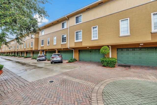 view of property with a garage and driveway