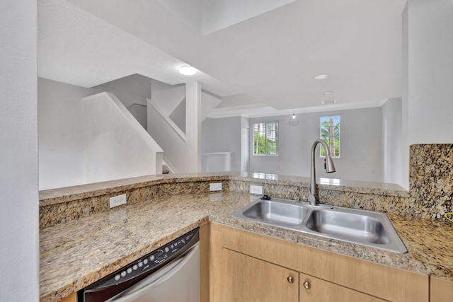kitchen with a sink, dishwasher, and light brown cabinets
