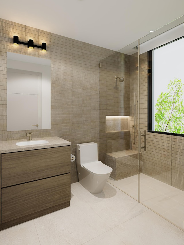 bathroom with tile patterned floors, vanity, tile walls, a tile shower, and toilet