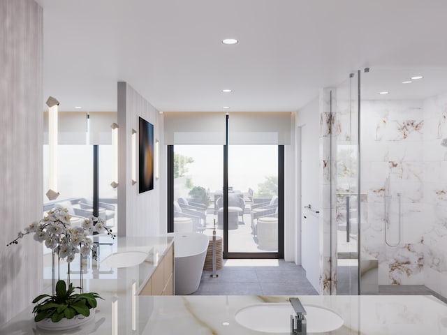 bathroom featuring recessed lighting, a soaking tub, vanity, and a stall shower