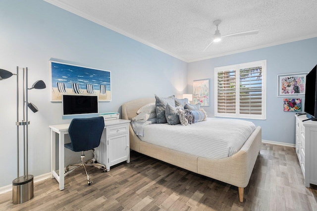 bedroom with ceiling fan, dark hardwood / wood-style flooring, a textured ceiling, and ornamental molding