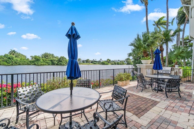 view of patio featuring a grill and a water view